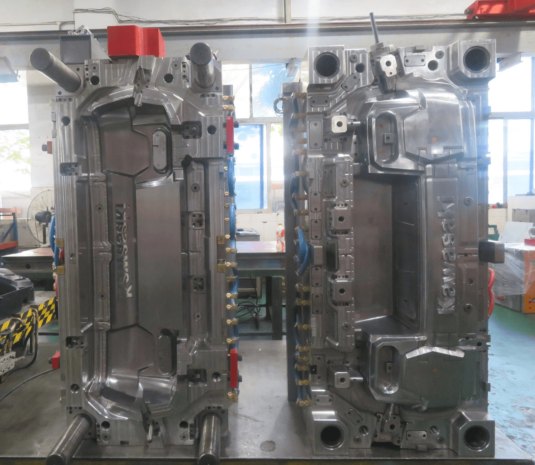 Open injection mold showing two matched tooling halves