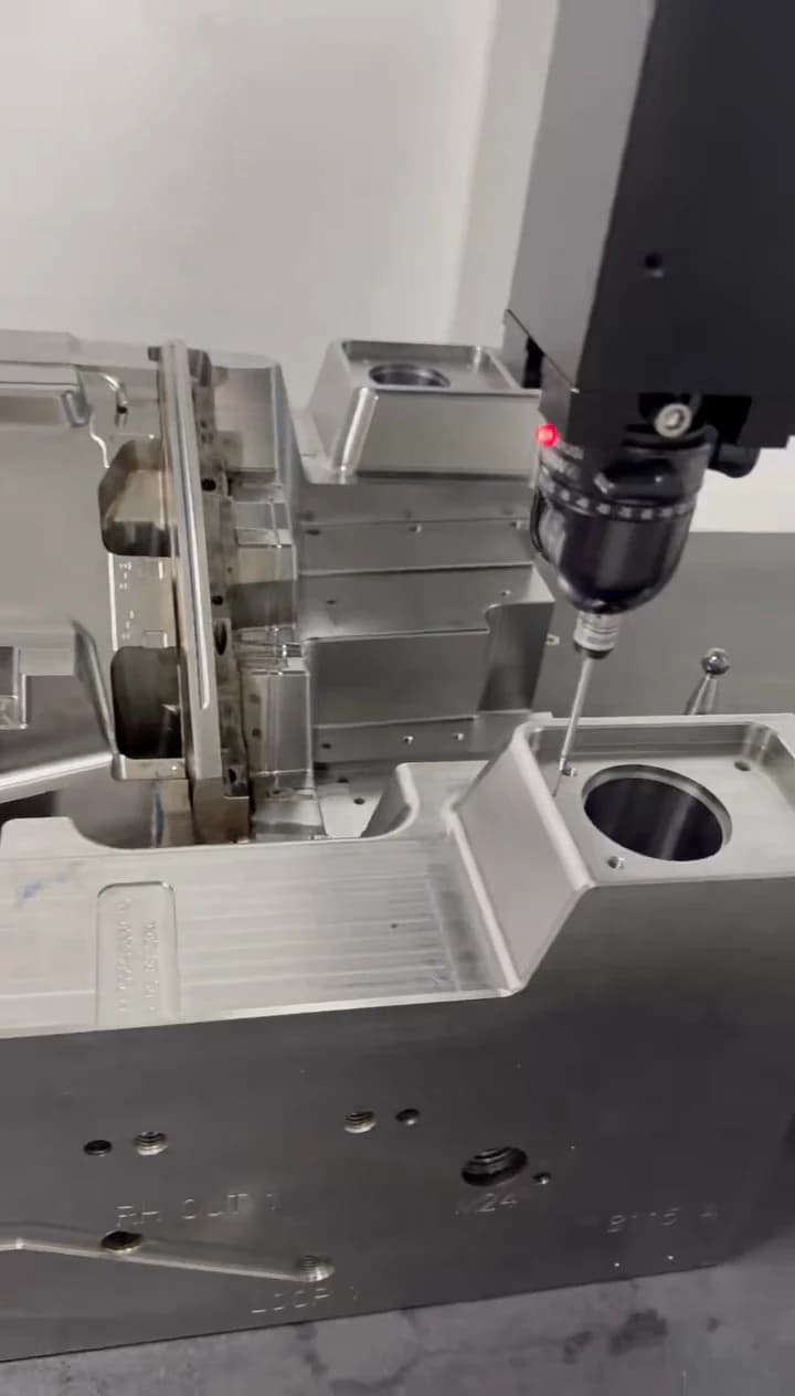 CMM probe checking a machined mold component